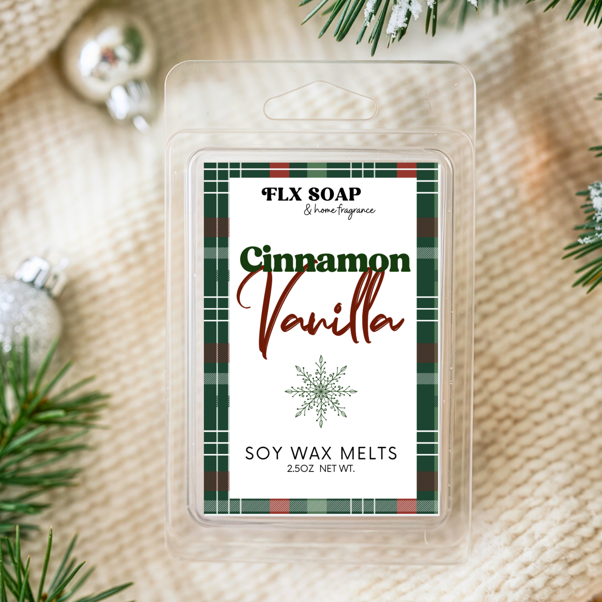 Cinnamon Vanilla soy wax melt packaging with Christmas decorations on a textured fabric background
