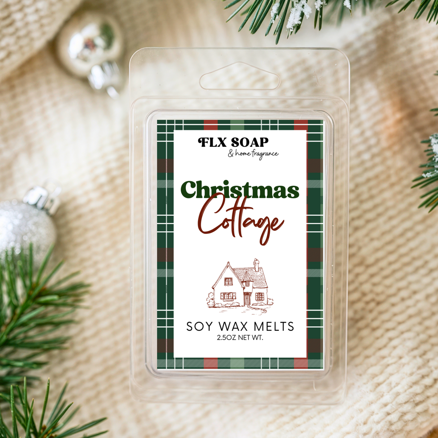 Pack of Christmas Cottage soy wax melts with decorative elements on a textured fabric background