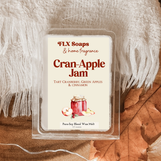 Cran-Apple Jam wax melt packaging on a decorative surface with leaves and lights