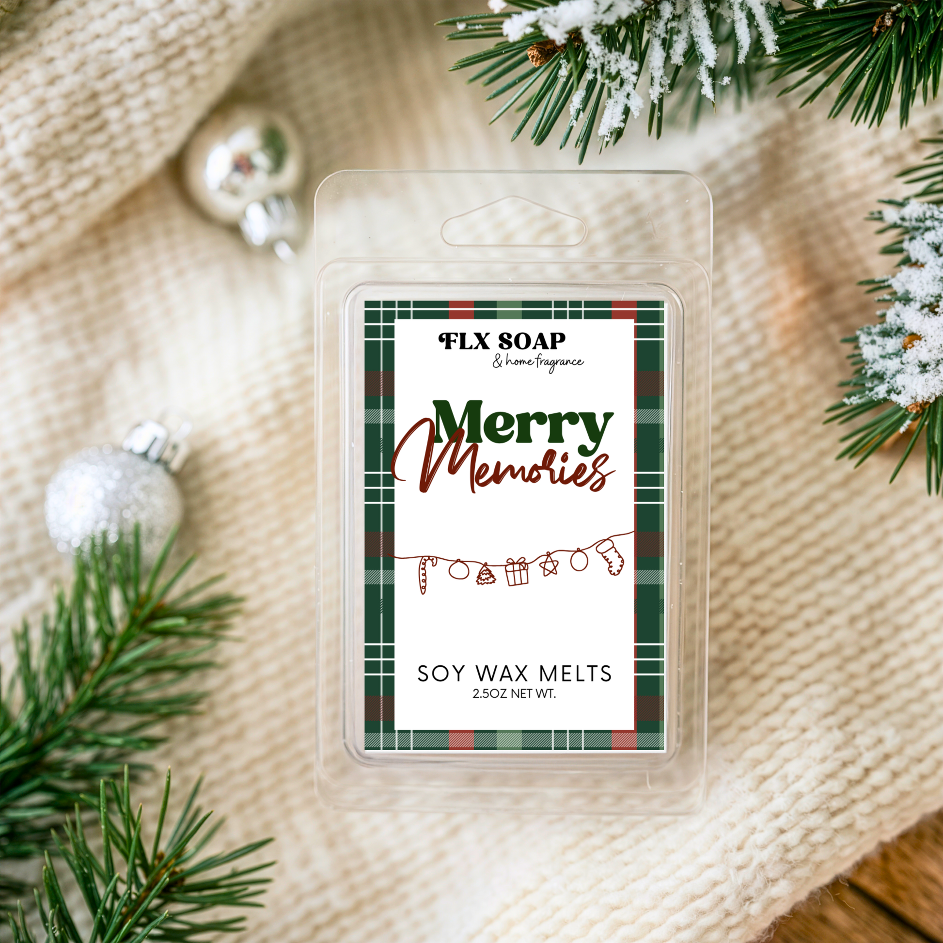 FLX SOAP soy wax melts packaging with 'Merry Memories' label on a textured surface with Christmas decorations.